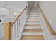 Elegant staircase featuring wood treads, white risers, and natural wood handrail at 125 Ridge Rd, Summerville, SC 29485