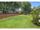 Grassy backyard featuring a trampoline, swing set, and tall wooden fence for privacy and shade at 1250 White Tail Path, Charleston, SC 29414