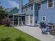 Blue home backyard featuring a screened porch, concrete patio, green grass, and an outdoor grill at 1250 White Tail Path, Charleston, SC 29414