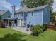 Exterior view of a blue two-story home with a screen porch and patio in a well-maintained backyard at 1250 White Tail Path, Charleston, SC 29414