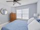 Bright bedroom featuring natural light, hardwood floors, a dresser, and blue decor accents at 1250 White Tail Path, Charleston, SC 29414
