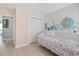 Bedroom with unique wall art and a floral-patterned daybed with a light colored wood floor at 1250 White Tail Path, Charleston, SC 29414