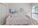 Bedroom with unique wall art and a floral-patterned daybed with a light colored wood floor at 1250 White Tail Path, Charleston, SC 29414