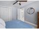 Bedroom with white closet doors, wood floors, and a view into the en suite bathroom, illuminated by natural light at 1250 White Tail Path, Charleston, SC 29414