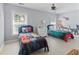 Bright ' bedroom with comic-themed bedsheets and dinosaur-themed wall art, a playful and imaginative space at 1250 White Tail Path, Charleston, SC 29414