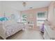 Bright and airy bedroom with painted walls, daybed, vanity and natural light from the windows at 1250 White Tail Path, Charleston, SC 29414