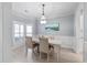 Bright dining room with hardwood floors, elegant lighting fixture, and doorway to kitchen at 1250 White Tail Path, Charleston, SC 29414
