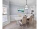 Bright dining room with hardwood floors, elegant lighting fixture, and doorway to kitchen at 1250 White Tail Path, Charleston, SC 29414