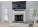 Close-up of a fireplace featuring a white mantel, decorative marble surround, and a mounted TV above the fireplace at 1250 White Tail Path, Charleston, SC 29414