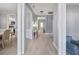 Hallway view with hardwood floors leading to the living room and dining area, painted in light grey at 1250 White Tail Path, Charleston, SC 29414
