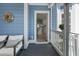 A cozy front porch with comfortable seating, is the perfect spot to enjoy the outdoors and welcome guests at 1250 White Tail Path, Charleston, SC 29414