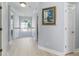 Hallway with hardwood floors, white trim, staircase landing, and an abundance of natural light at 1250 White Tail Path, Charleston, SC 29414