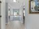 Upstairs hallway with light-colored wood floors and natural light from the window at the end of the hall at 1250 White Tail Path, Charleston, SC 29414