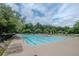 Community pool featuring lounge chairs, swimming lanes, and mature trees providing shade at 1250 White Tail Path, Charleston, SC 29414