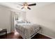 Bedroom with hardwood floors, ceiling fan, and cozy bed setup at 130 Shropshire St, Goose Creek, SC 29445