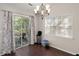Dining area with chandelier, sliding door to backyard, and a large window with natural light at 130 Shropshire St, Goose Creek, SC 29445