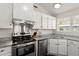 Updated kitchen featuring stainless steel appliances, granite countertops, and sleek white cabinetry at 130 Shropshire St, Goose Creek, SC 29445