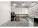Modern kitchen with white cabinets, granite countertops, stainless steel appliances, and ample natural light at 130 Shropshire St, Goose Creek, SC 29445