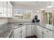 Well-lit kitchen with stainless steel sink, granite countertops, modern appliances, and view to the outside at 130 Shropshire St, Goose Creek, SC 29445