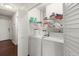 Functional laundry room featuring washer, dryer, and storage shelves for organization at 130 Shropshire St, Goose Creek, SC 29445
