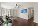 Open living room with hardwood floors, a comfortable black leather sofa, and bright, natural light at 130 Shropshire St, Goose Creek, SC 29445