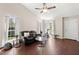 Open living room with hardwood floors, a comfortable black leather sofa, and bright, natural light at 130 Shropshire St, Goose Creek, SC 29445