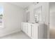Well-lit bathroom featuring a double sink vanity with white cabinetry and large mirrors at 133 Brant Dr, Summerville, SC 29483