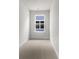 Hallway area with carpeted floors, white walls, and a bright window bringing in natural light at 133 Brant Dr, Summerville, SC 29483