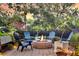 Cozy backyard patio featuring a stone fire pit, comfortable seating, and beautiful landscaping at 134 Etiwan Park St, Charleston, SC 29492