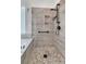 Bathroom showcasing a tile shower with river rock flooring and a glass partition at 134 Etiwan Park St, Charleston, SC 29492