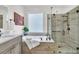 Bathroom showcasing a glass shower, soaking tub, tile and river rock flooring at 134 Etiwan Park St, Charleston, SC 29492