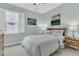 Light-filled bedroom with light green walls, white bedding, and stylish nightstands and decor at 134 Etiwan Park St, Charleston, SC 29492