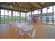Spacious clubhouse interior with wooden tables, chairs and large windows with nature views at 134 Etiwan Park St, Charleston, SC 29492