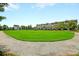 A wide open common green with a walking path, framed by the community at 134 Etiwan Park St, Charleston, SC 29492