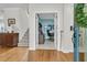 Inviting entryway with hardwood floors, staircase, and an office view featuring a blue accent wall at 134 Etiwan Park St, Charleston, SC 29492
