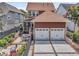 Rear exterior with two-car garage, patio with seating, and landscaped yard featuring a fence, garden, and screened-in porch at 134 Etiwan Park St, Charleston, SC 29492