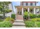 Charming front entrance with a classic porch and inviting walkway with lush landscaping at 134 Etiwan Park St, Charleston, SC 29492