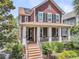 Inviting two-story home with a classic front porch and well-maintained landscaping and solar panels at 134 Etiwan Park St, Charleston, SC 29492