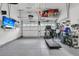 Organized garage space with epoxy flooring, shelving, and a wall-mounted television at 134 Etiwan Park St, Charleston, SC 29492