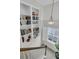 Hallway with custom built-in shelving and a large window bringing in natural light at 134 Etiwan Park St, Charleston, SC 29492