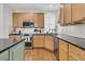 Modern kitchen equipped with stainless steel appliances, granite countertops, and wooden cabinetry at 134 Etiwan Park St, Charleston, SC 29492