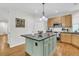 Well-lit kitchen featuring a center island, wooden cabinets, and modern appliances at 134 Etiwan Park St, Charleston, SC 29492
