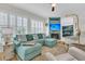 Cozy living room featuring a plush sectional, fireplace, hardwood floors, and abundant natural light at 134 Etiwan Park St, Charleston, SC 29492