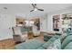 Open-concept living room flows to kitchen, with hardwood floors, comfortable seating, and bright natural light at 134 Etiwan Park St, Charleston, SC 29492