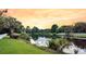 Scenic view of a serene pond reflecting the sunset sky, surrounded by lush greenery and trees at 134 Etiwan Park St, Charleston, SC 29492
