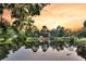 Scenic sunset view of a home on a pond surrounded by mature trees at 134 Etiwan Park St, Charleston, SC 29492