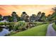 Picturesque view of a pond with a grassy shoreline and trees at 134 Etiwan Park St, Charleston, SC 29492