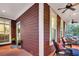 Inviting covered porch features comfortable wicker furniture and ceiling fans for relaxed outdoor living at 134 Etiwan Park St, Charleston, SC 29492