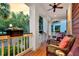 Inviting porch with wicker furniture and potted plants, ideal for relaxing and enjoying the outdoors at 134 Etiwan Park St, Charleston, SC 29492