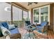 Cozy sunroom featuring wicker furniture, bright cushions, and screened windows at 134 Etiwan Park St, Charleston, SC 29492